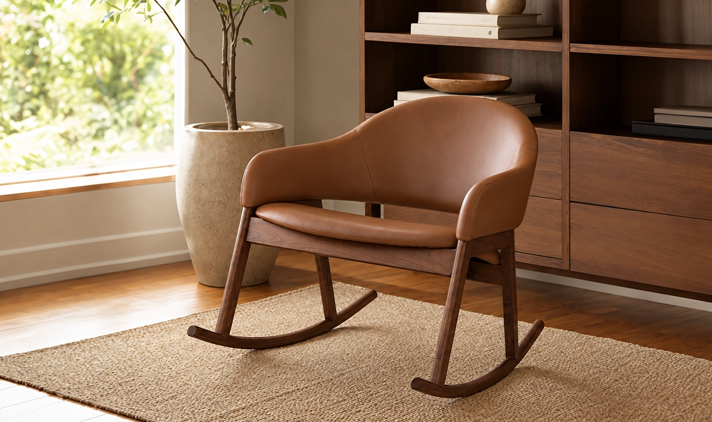 Tan leather rocking chair with walnut wood frame on a woven jute rug
